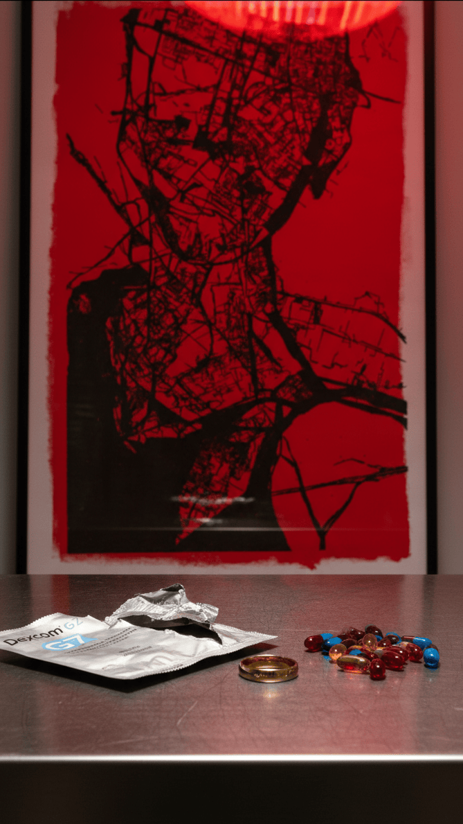 Red and black pen plotter generative art above a styled console table — algorithmic artwork as bold interior accent for home offices and living spaces.