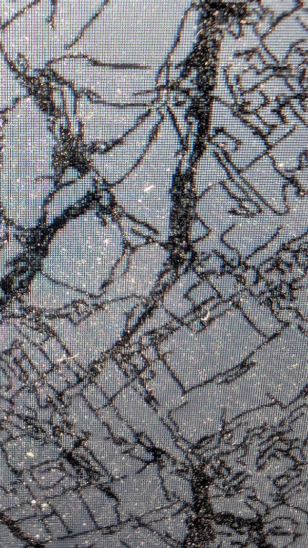 Macro detail of pen plotter generative art — black ink algorithmic patterns on reflective metallic silver paper. Original machine-drawn artwork for tech-forward collectors.