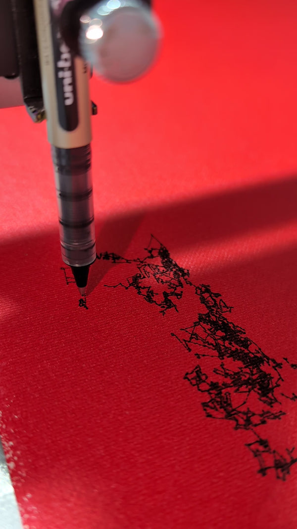 Closeup of a pen plotter drawing with black pen on red canvas